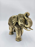 Ornate small brass elephant sculpture with decorative engravings, side view