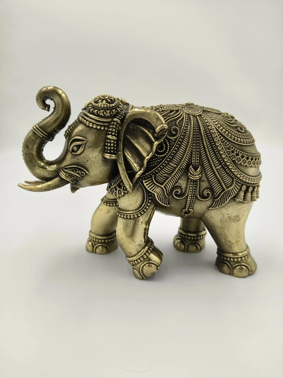Handcrafted small brass elephant sculpture with detailed ornamental patterns