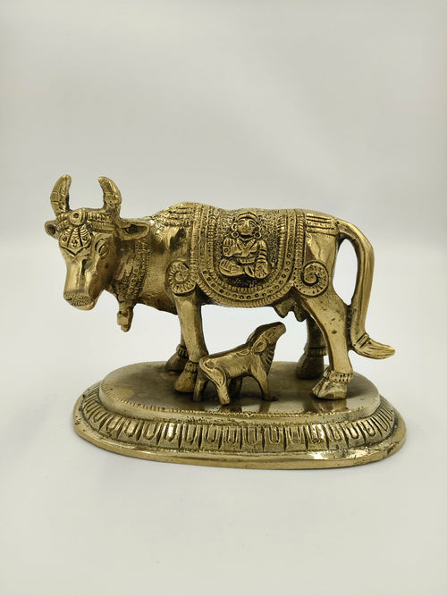 Small brass figurine of a cow with calf on decorative base