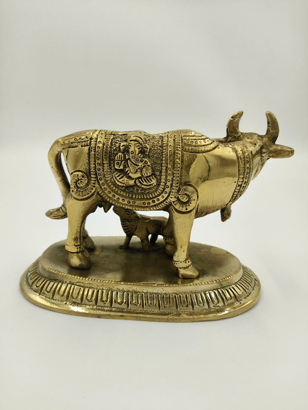 Small brass cow and calf figurine with engraved decorative patterns