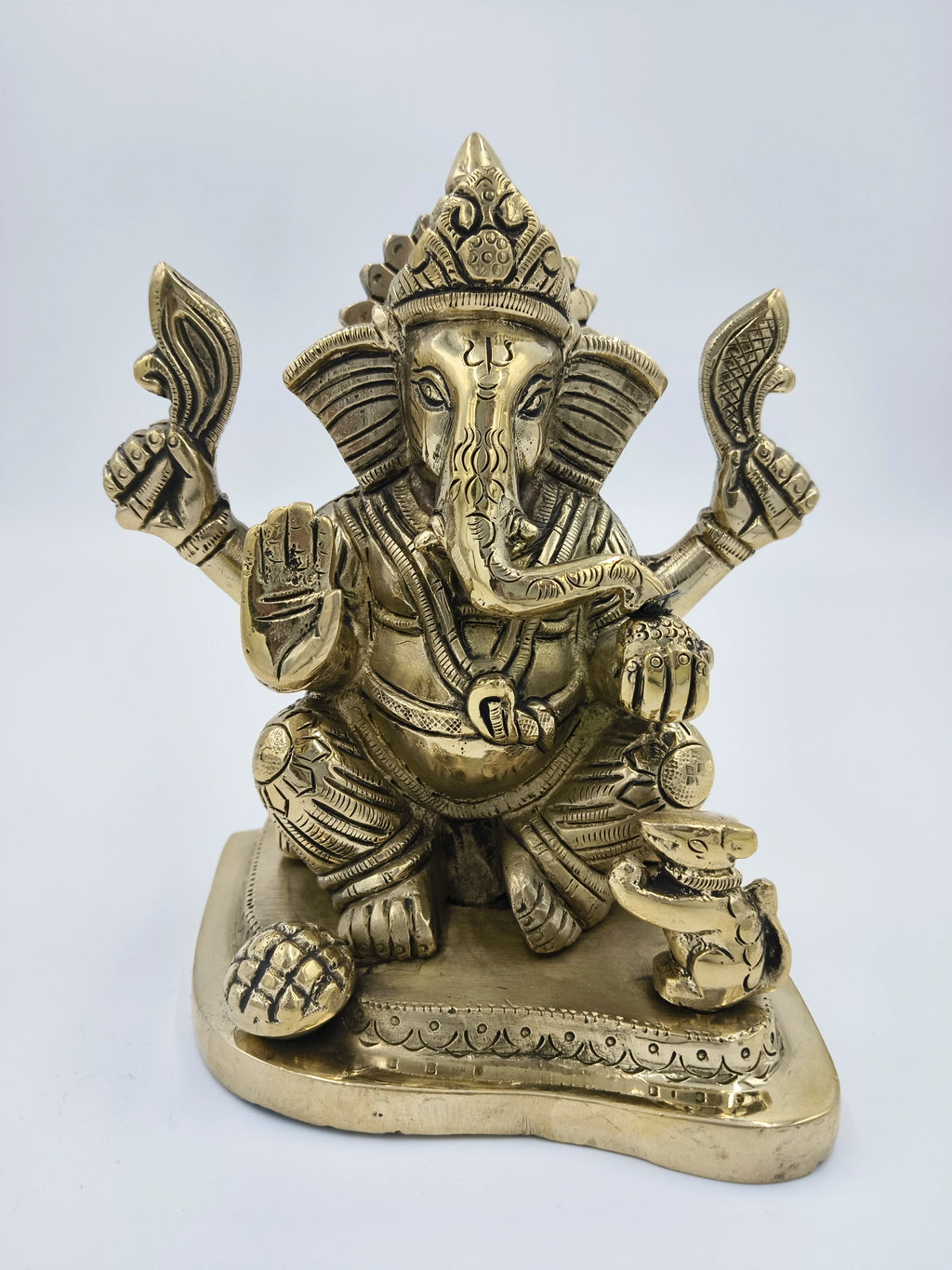Large brass Raja Ganapati statue with detailed carvings and seated on a decorative base
