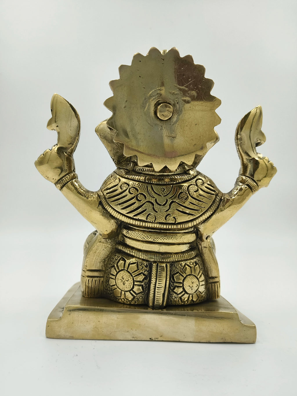 Back view of large brass Raja Ganapati statue with detailed engravings