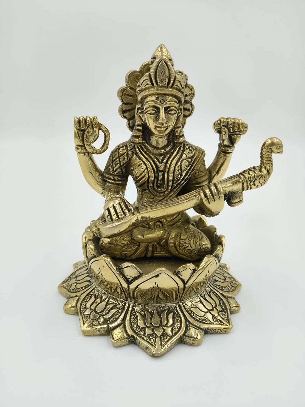 Brass statue of Saraswathi seated on lotus with veena and intricate detailing