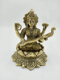 Brass statue of Saraswathi seated on lotus with veena and intricate detailing