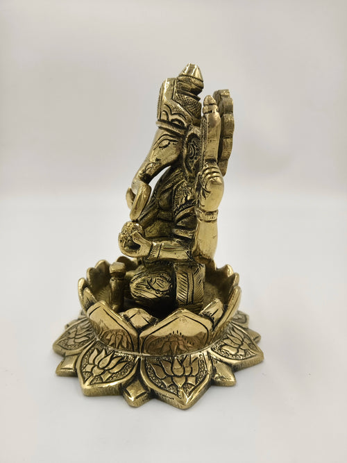 Brass Padma Hasta Ganapati statue seated on a lotus base, side view