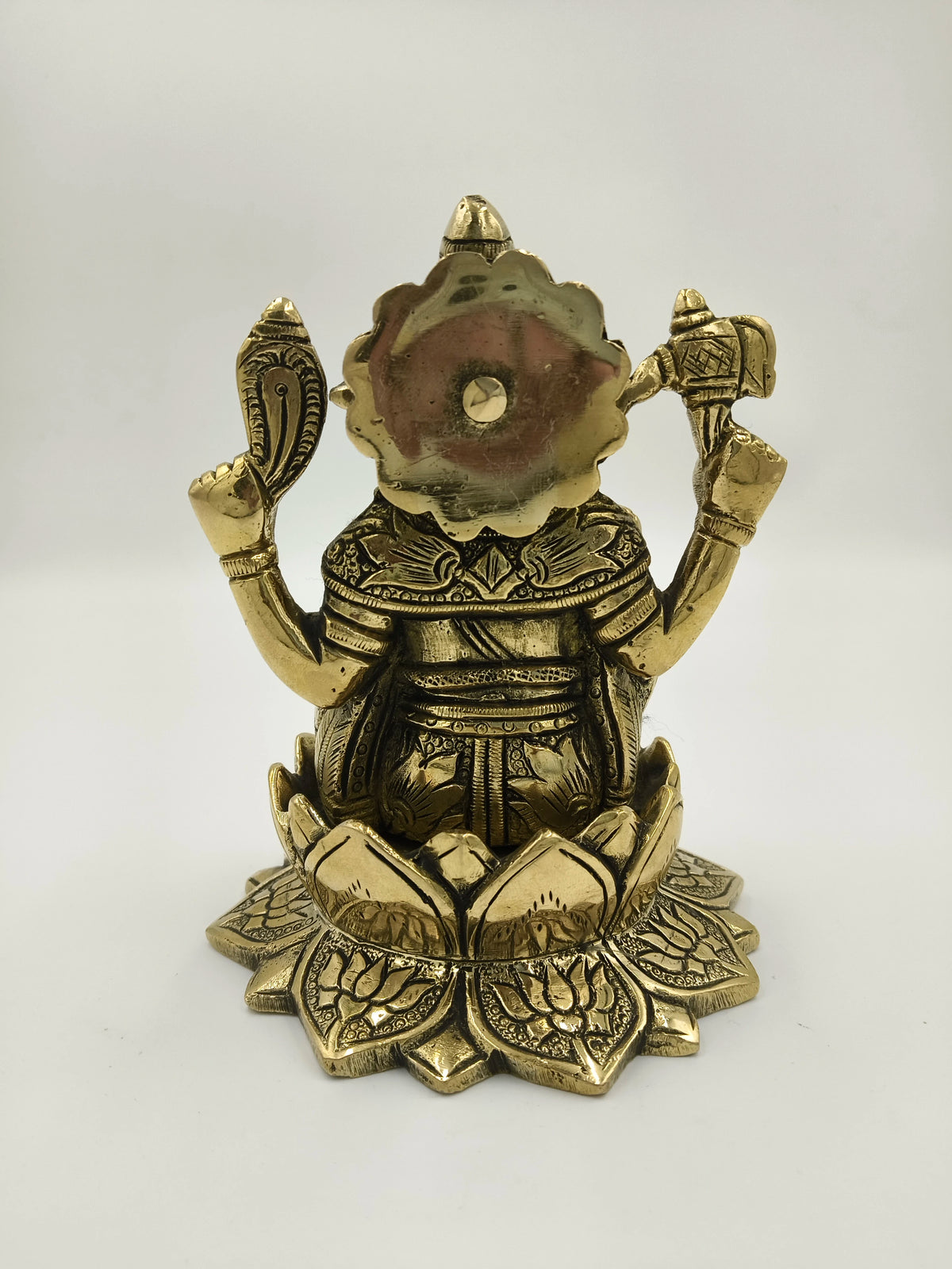 Rear view of brass Padma Hasta Ganapati statue seated on a lotus pedestal