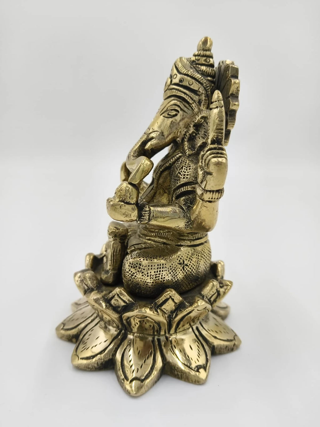 Brass statue of Padma Hasta Ganapati sitting on a lotus base side view