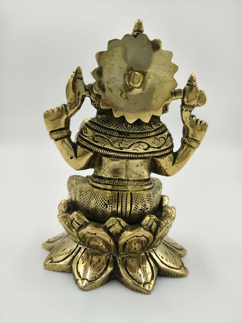 Back view of brass Padma Hasta Ganapati statue seated on lotus base