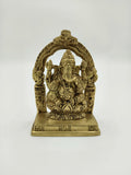 Small brass sculpture of Lord Ganesha seated with decorative arch on base