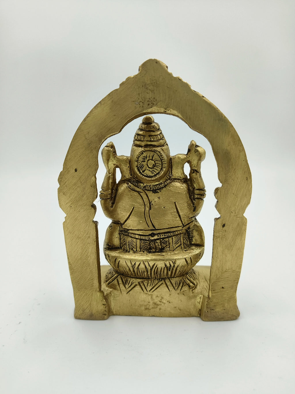 Small brass Ganesha sculpture with decorative arch, rear view