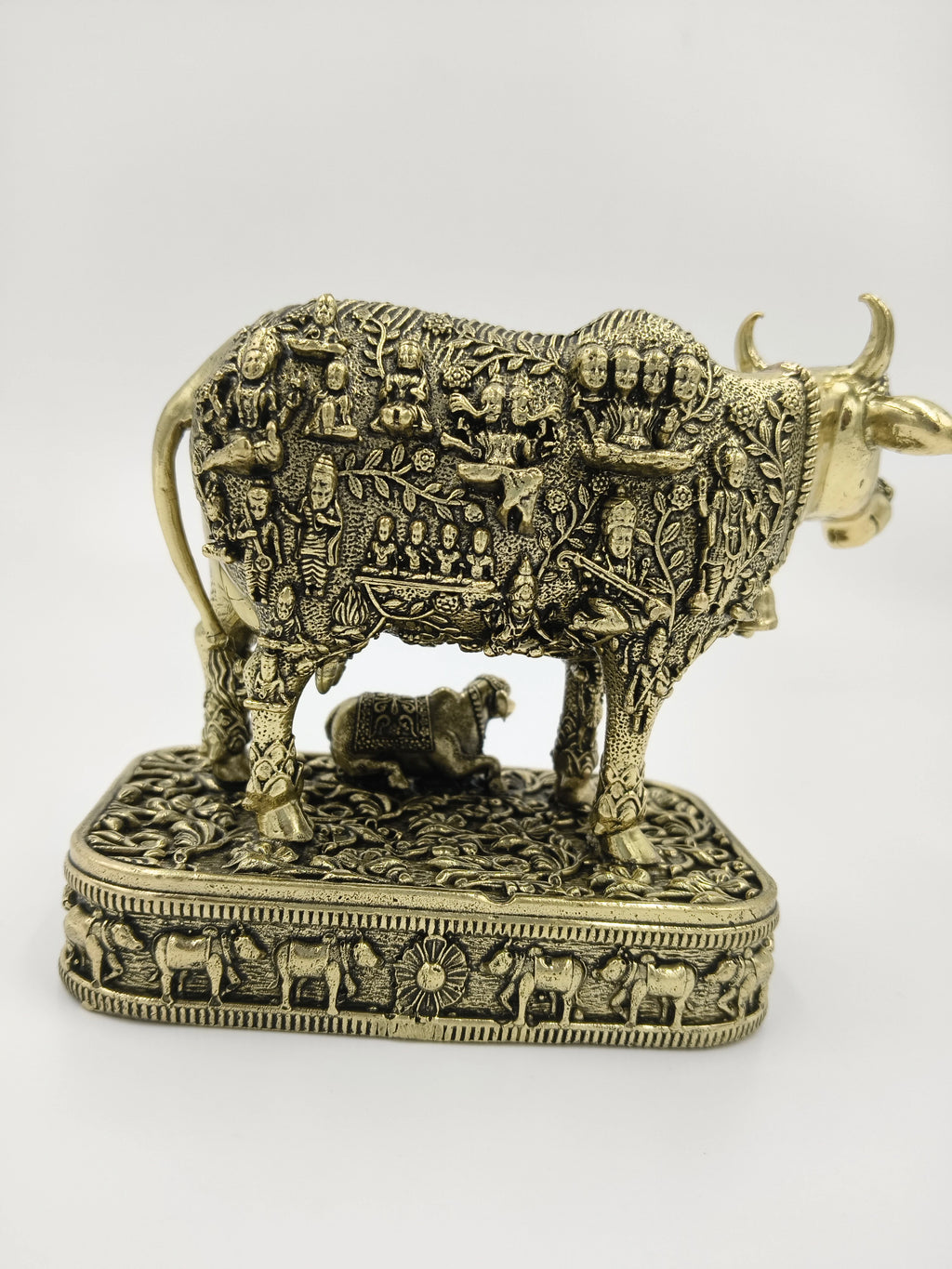 Small brass sculpture of a cow with calf on ornate rectangular base