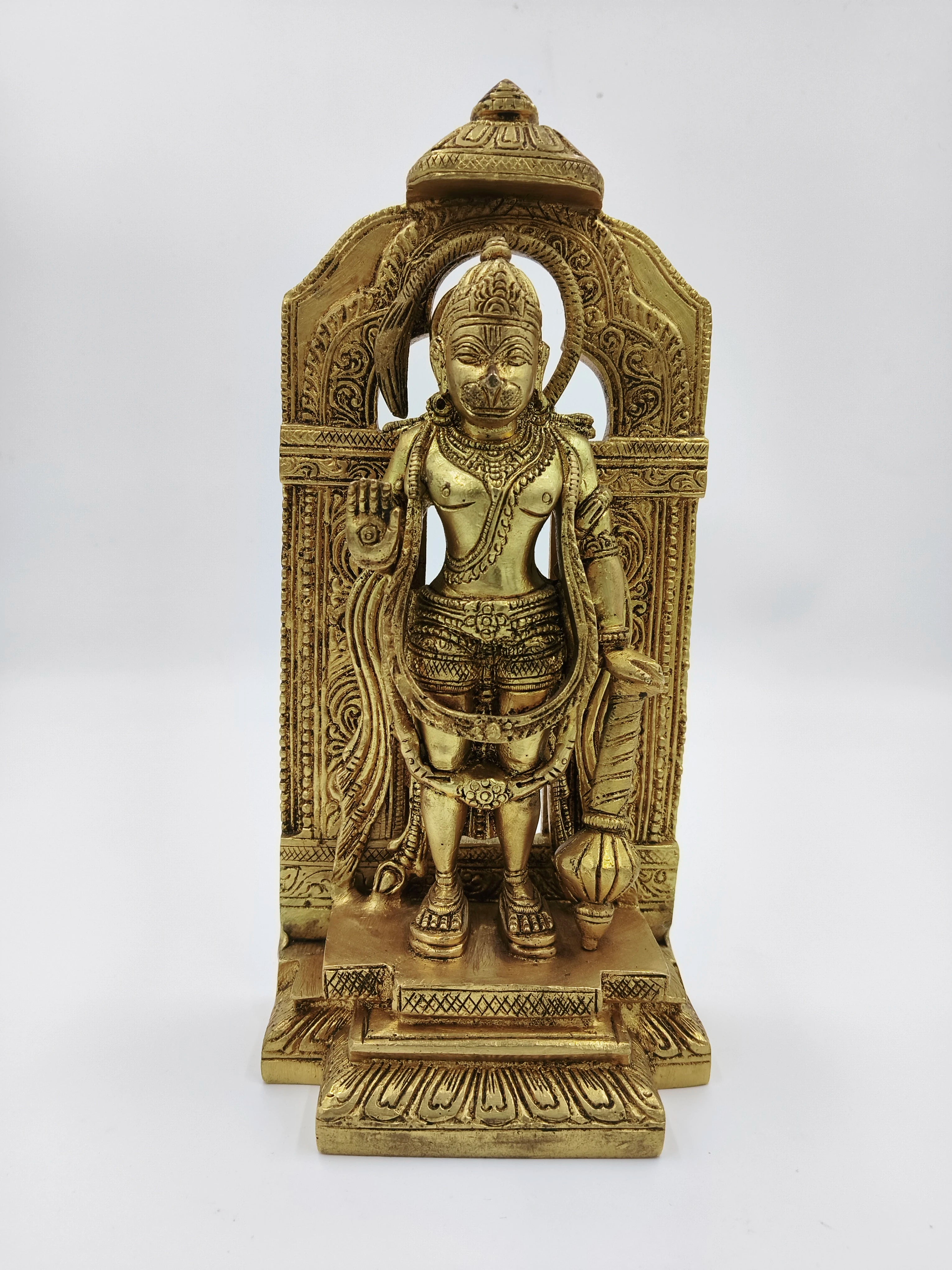 Brass standing Hanuman statue with ornate arch backdrop, front view