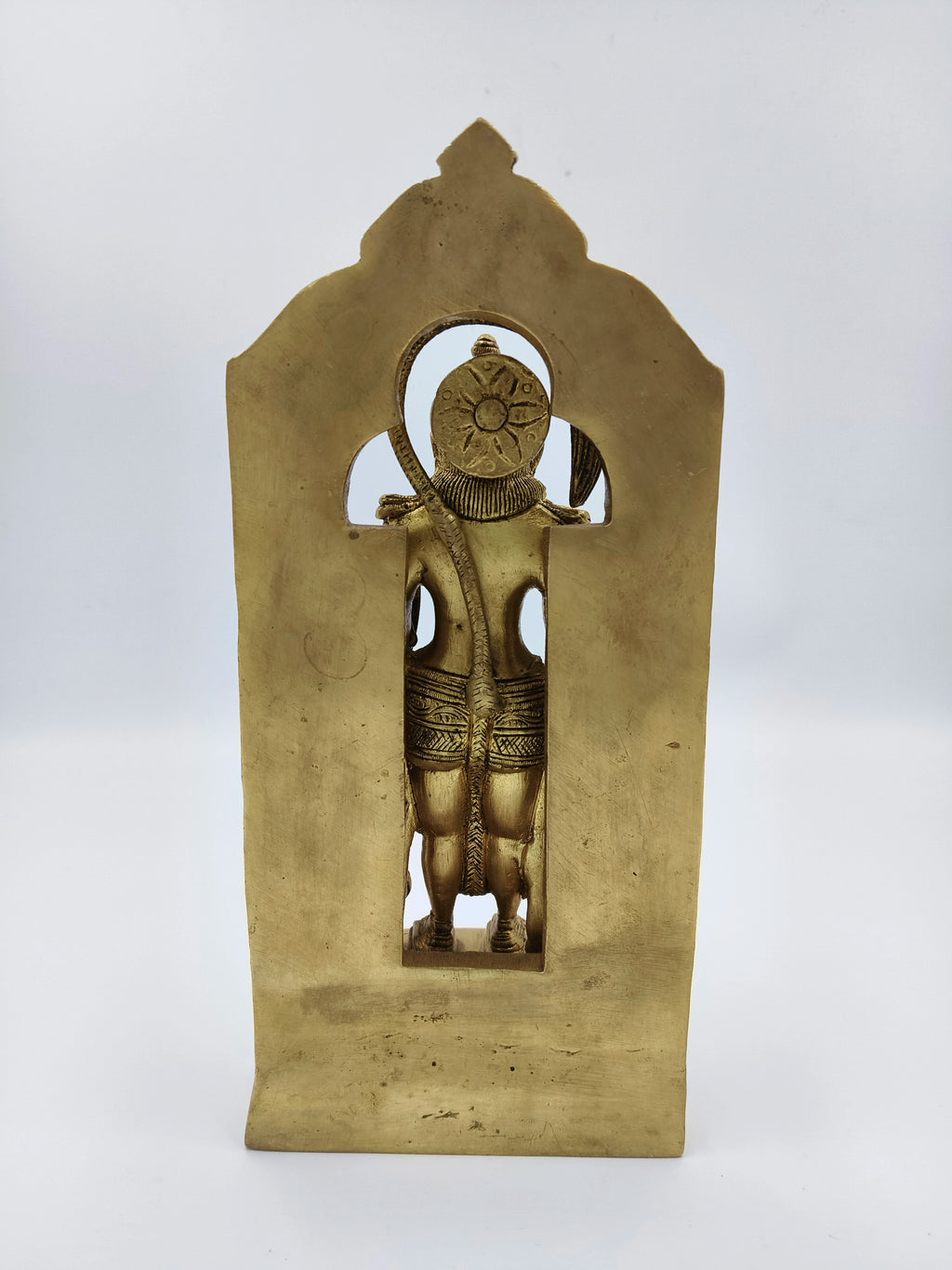 Back view of large brass standing Hanuman sculpture with arch frame