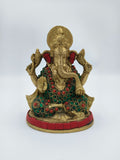 Front view of medium brass Ganesh sculpture with red and green embellishments