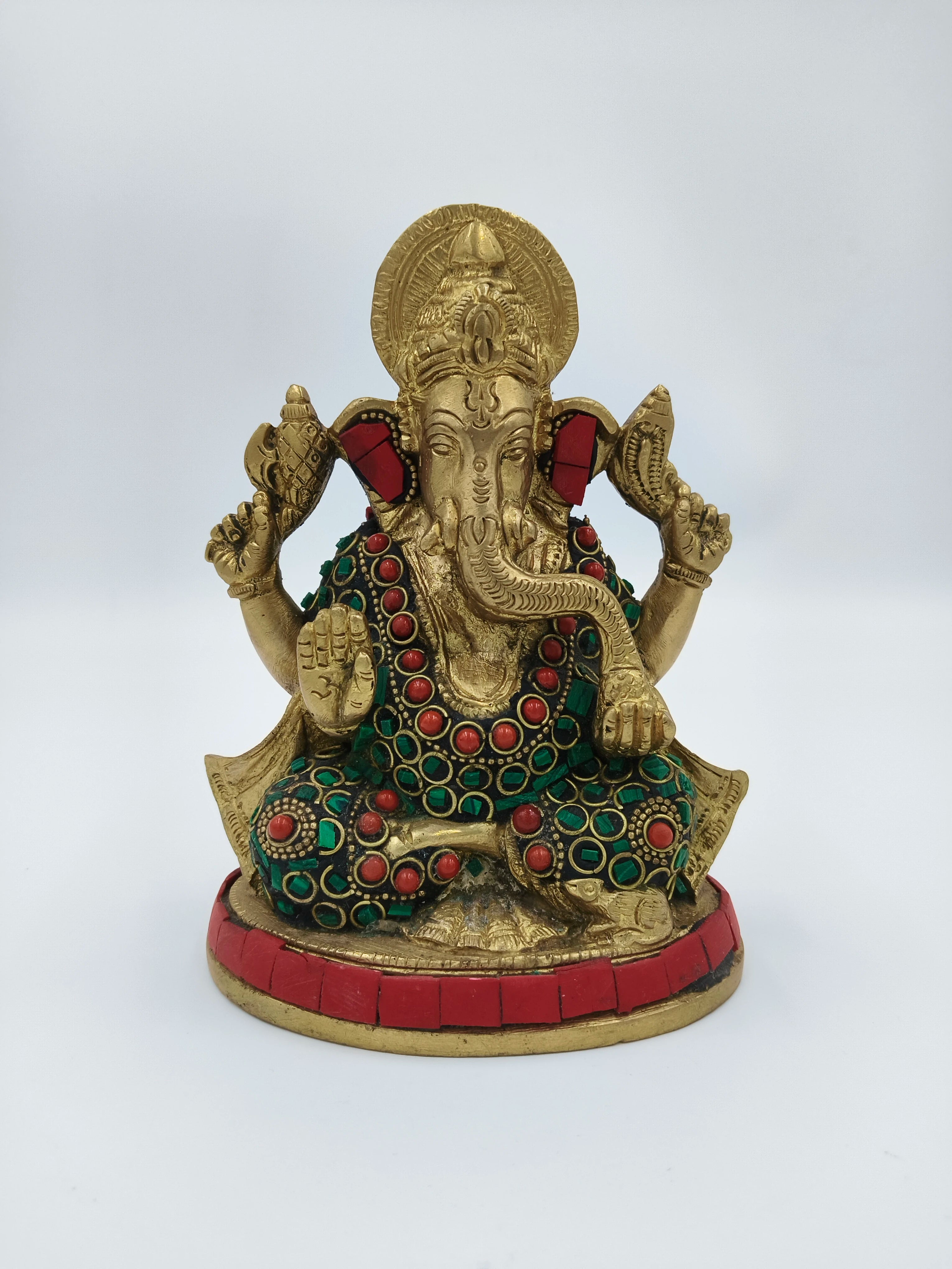 Front view of medium brass Ganesh sculpture with red and green embellishments