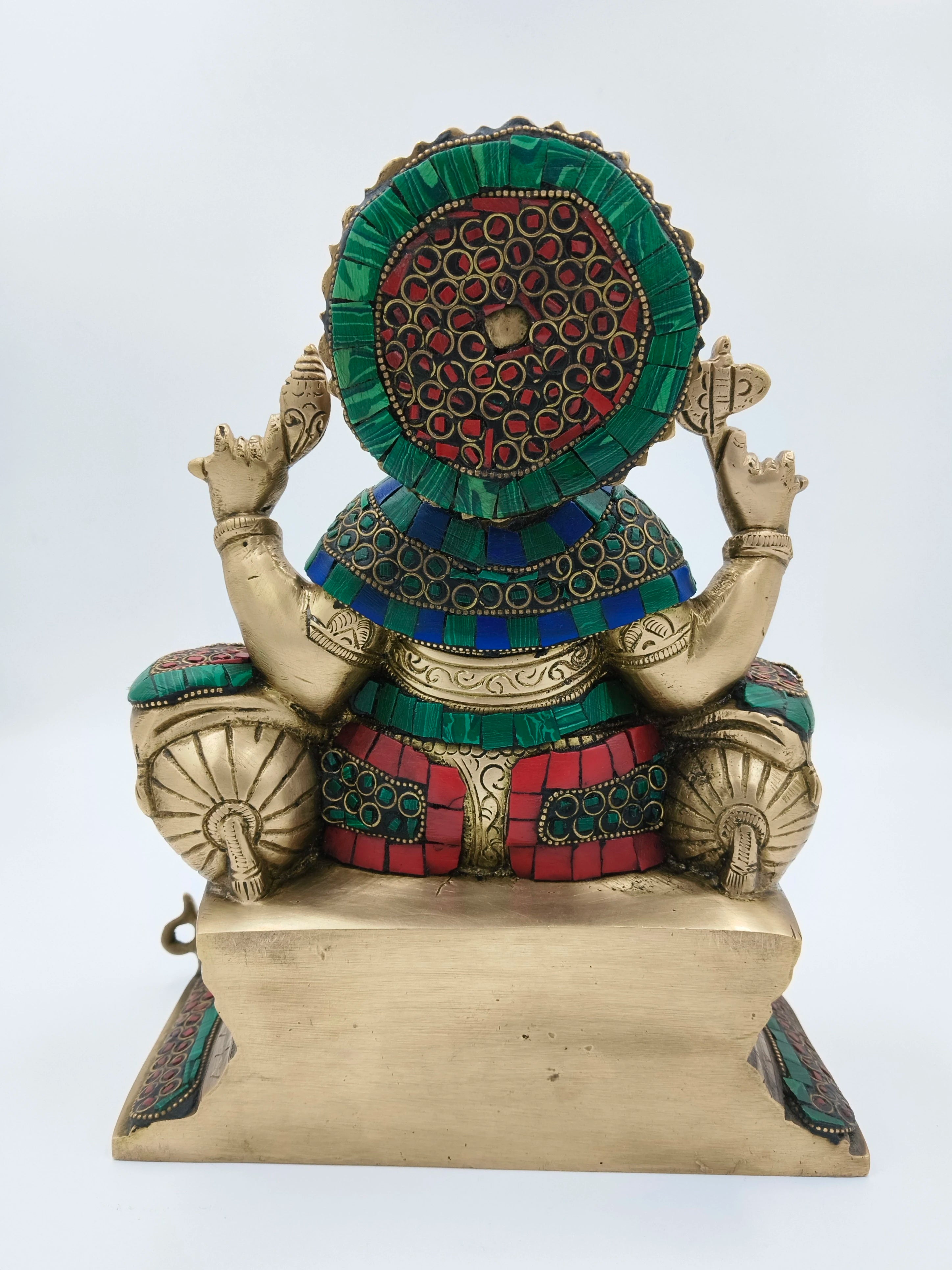 Rear view of large brass Ganesh statue with colorful inlaid decorations