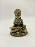 Small brass sculpture of seated Annapoorna goddess holding a ladle and bowl