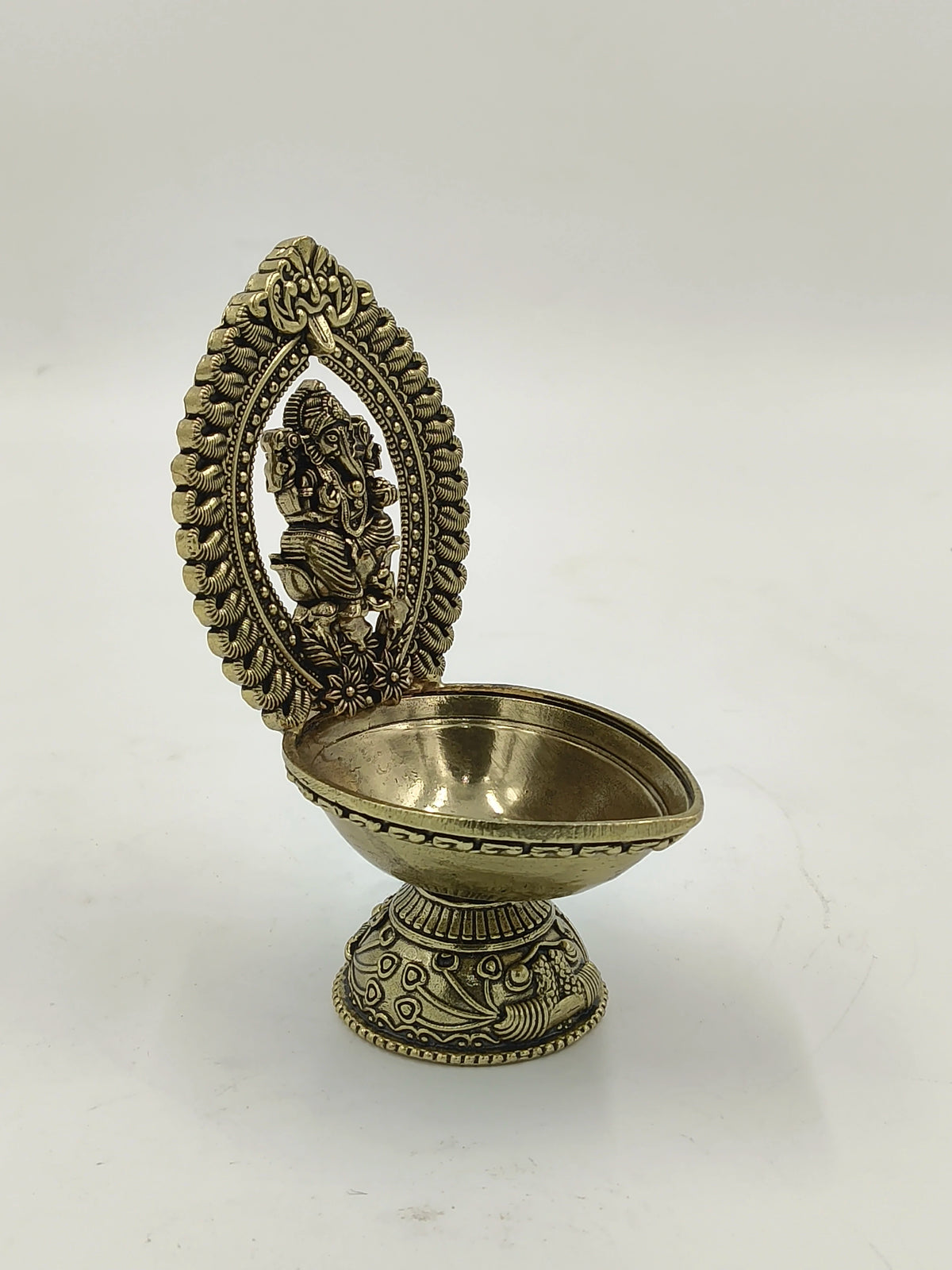 Brass Ganesh deep lamp with decorative arch and floral base