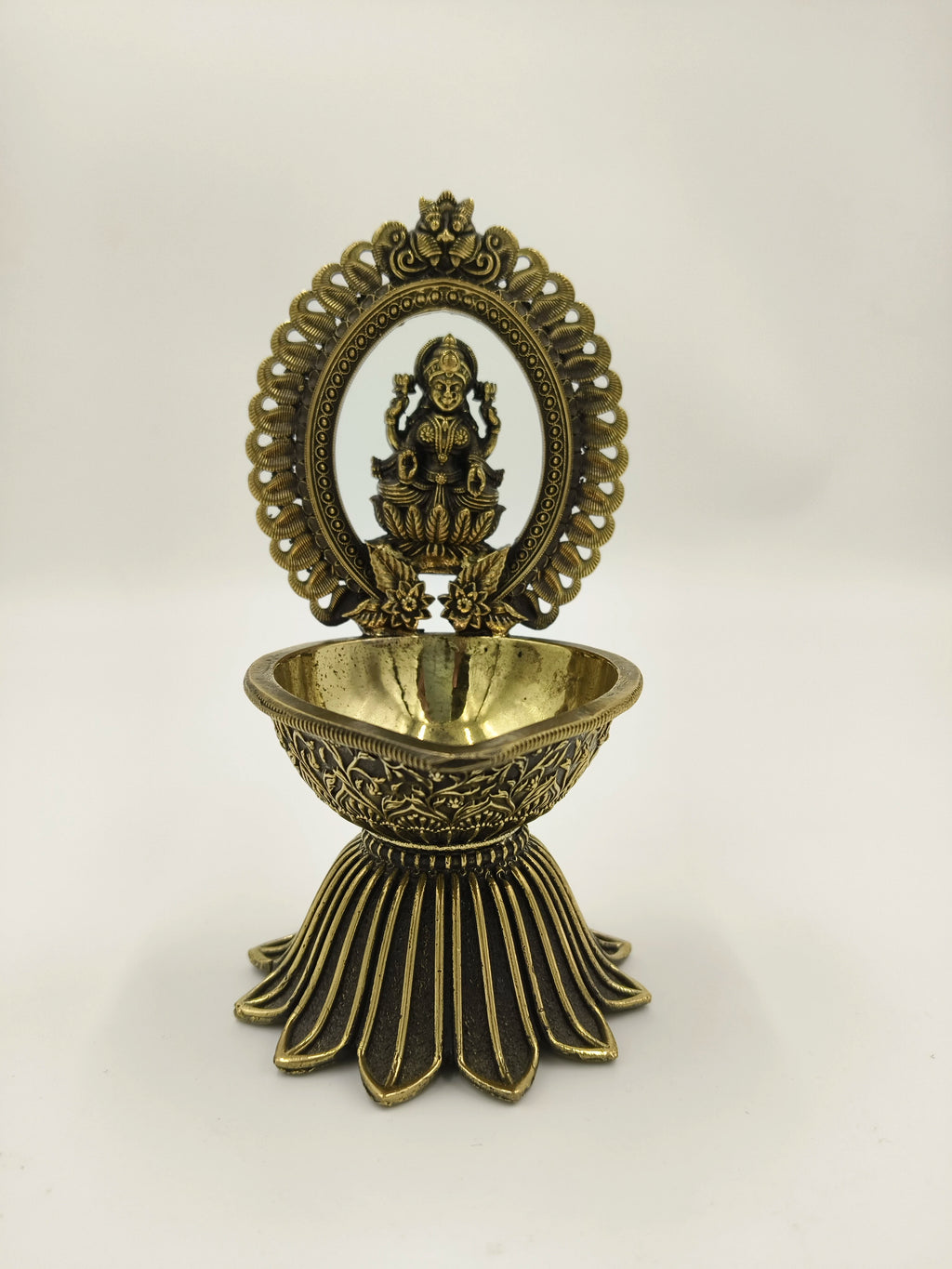 Brass decorative arch with Lakshmi idol and deep diya holder