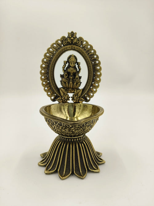 Brass decorative arch with Lakshmi idol and deep diya holder