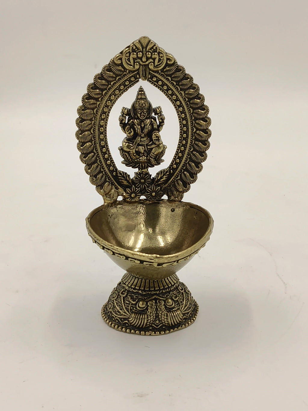 Medium brass Lakshmi idol with decorative arch and bowl base