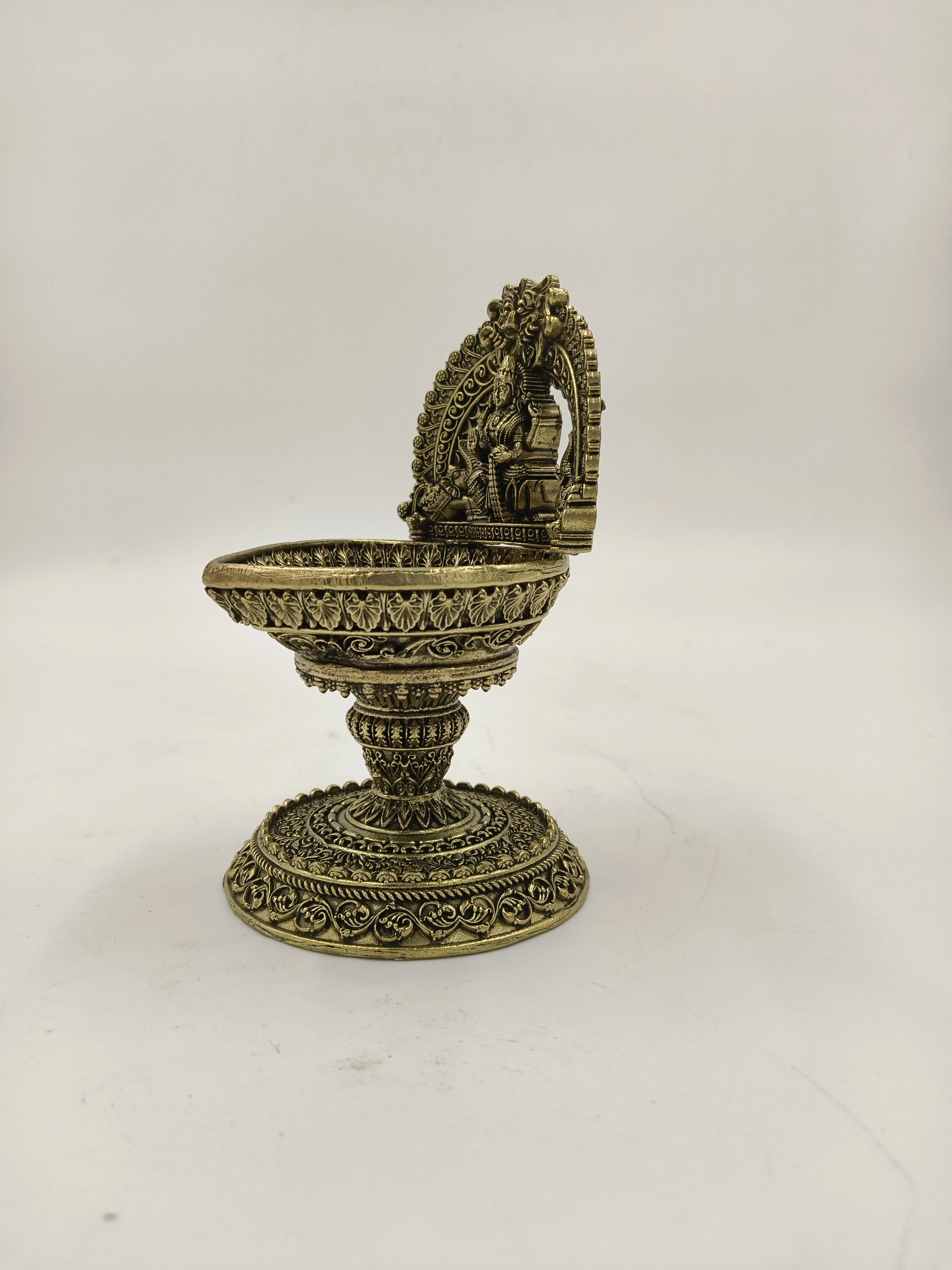 Brass Lakshmi diya lamp with detailed arch and pedestal base side view