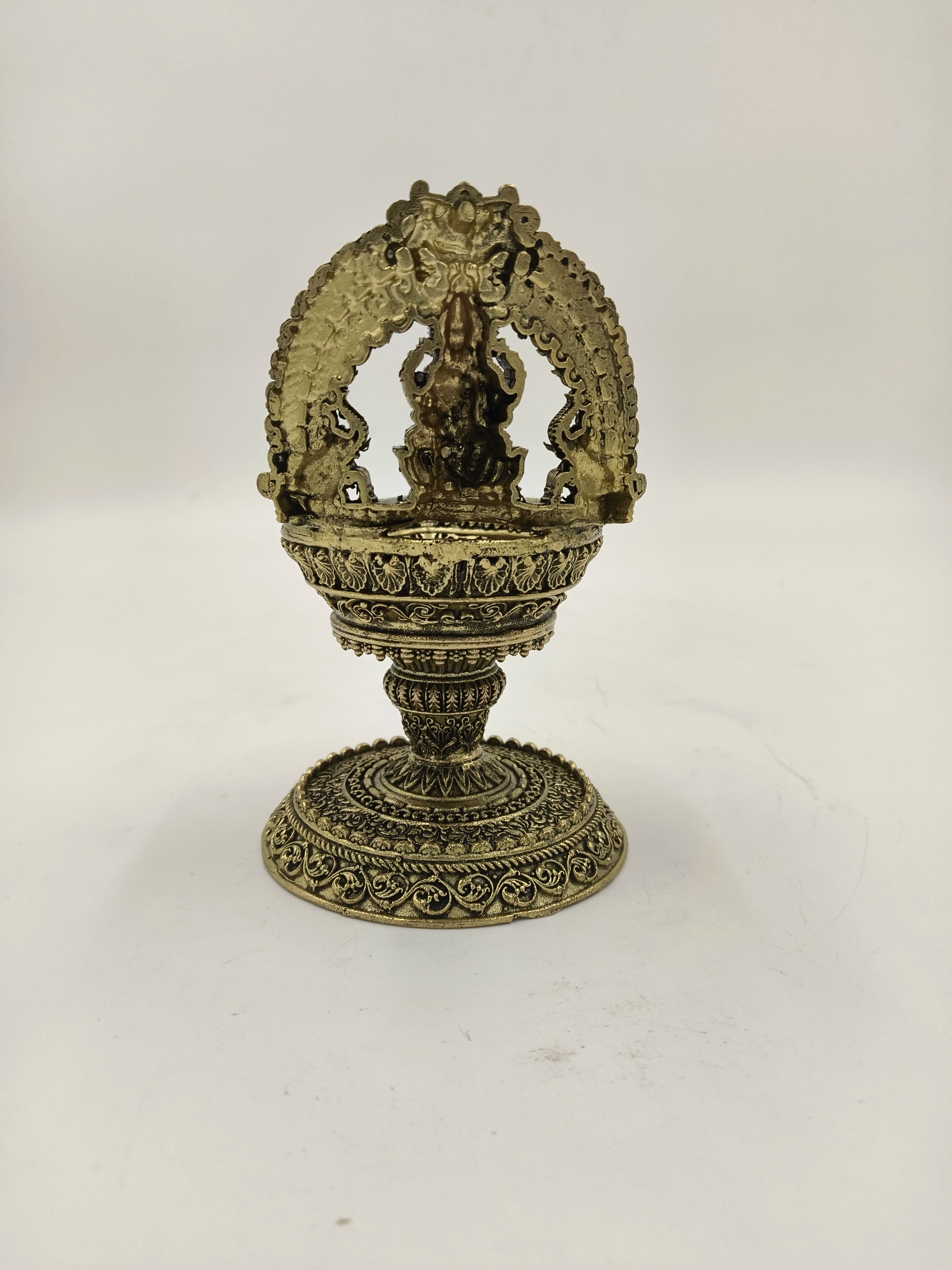 Brass sculpture with decorative arch and pedestal base