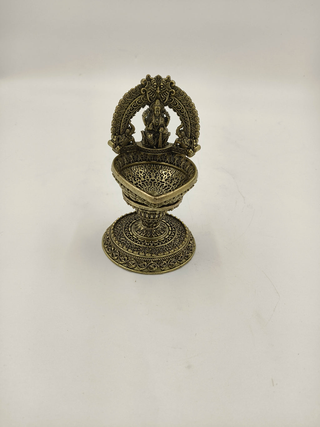 Medium brass Lakshmi idol with decorative arch and deep bowl base