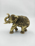 Small brass elephant sculpture with intricate decorative patterns side view