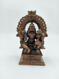 Medium copper sculpture of Narasimha Swami seated under ornamental arch