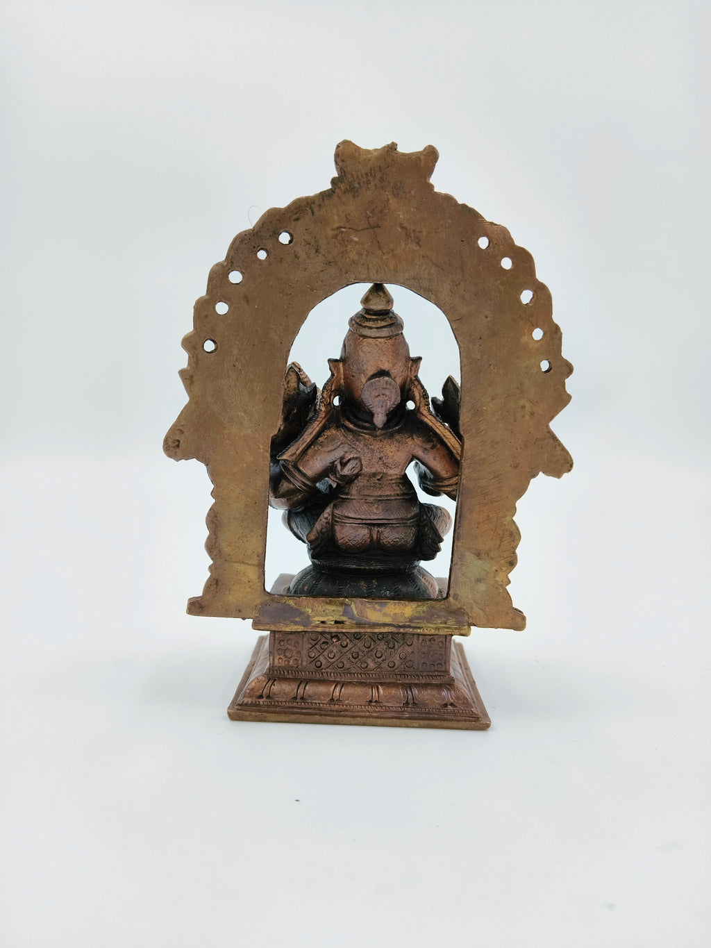 Back view of medium copper Narasimha Swami sculpture with intricate arch frame