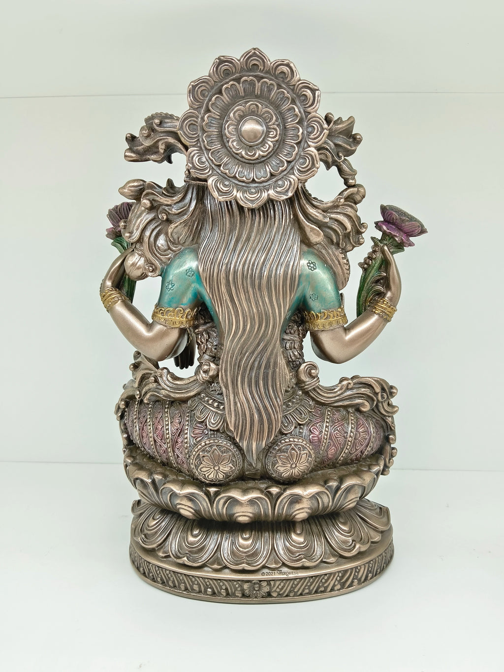Back view of large polyresin statue of Goddess Lakshmi seated on lotus