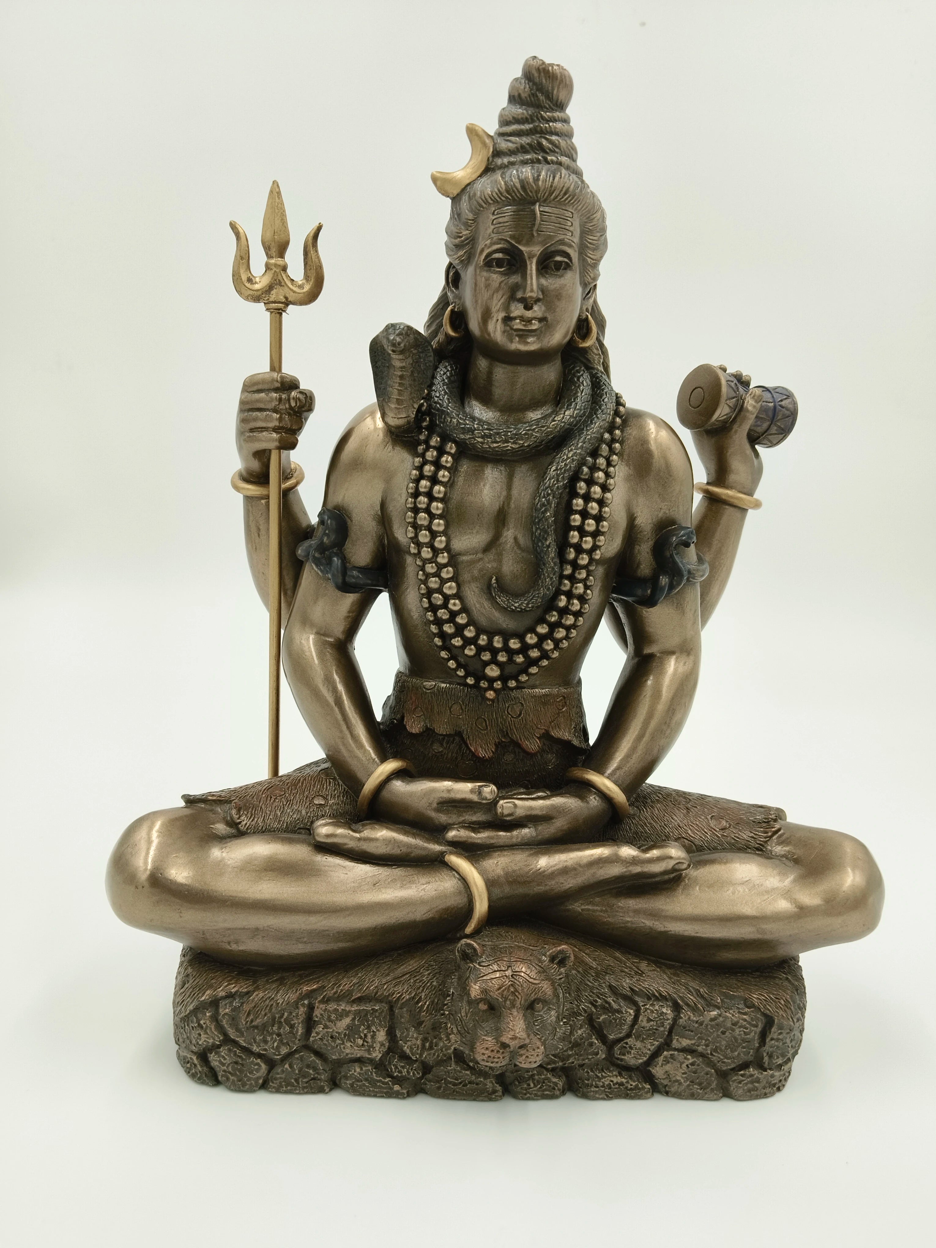 Large polyresin sculpture of Shiva seated in lotus pose with trident and drum