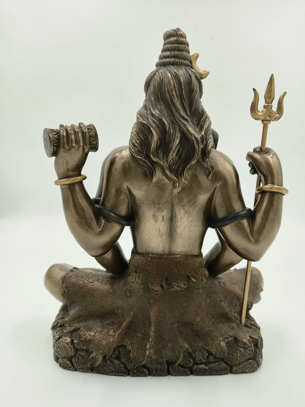Back view of large polyresin Shiva statue holding trident and drum