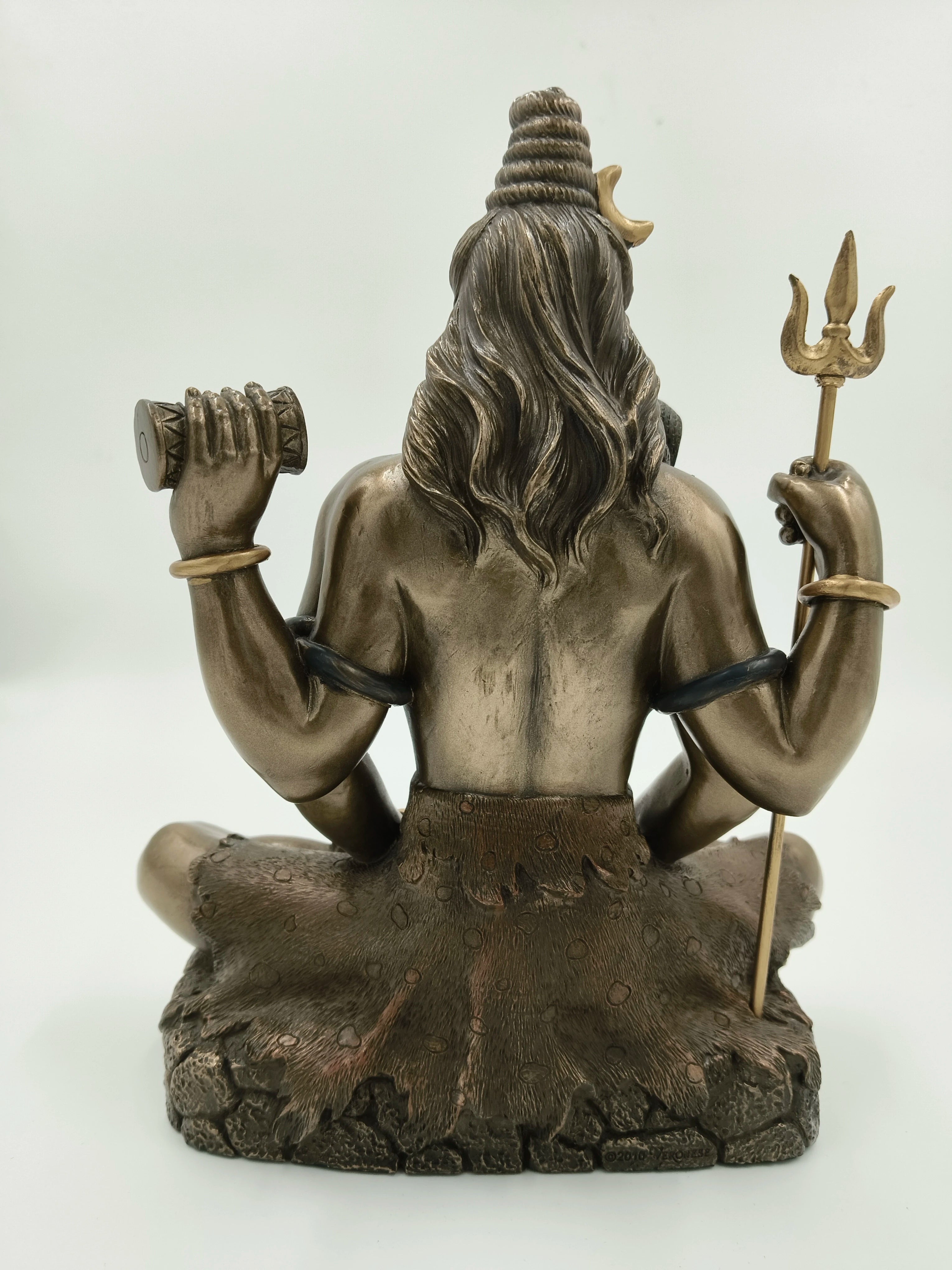 Back view of large polyresin Shiva statue holding trident and drum