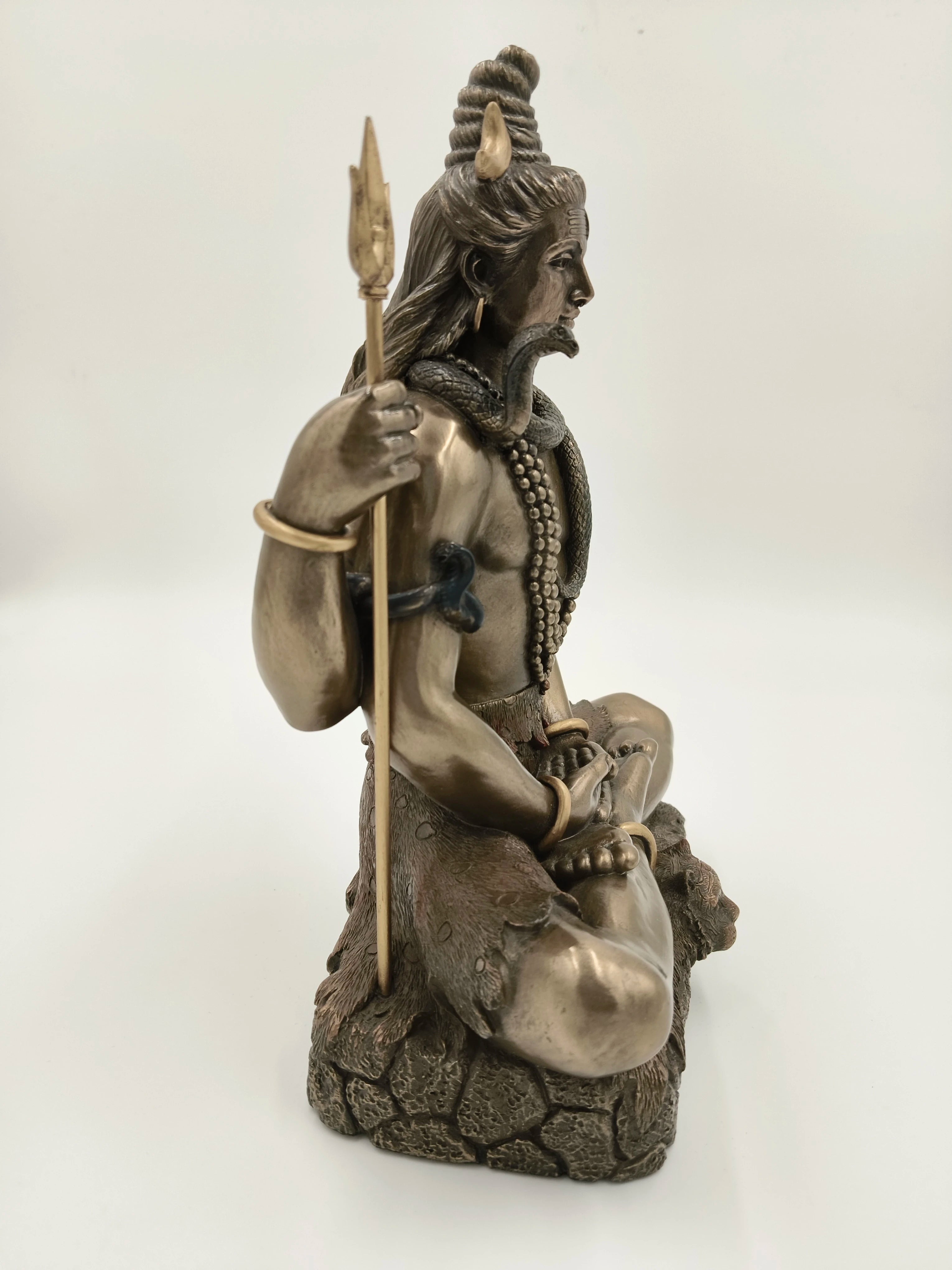 Polyresin sculpture of Shiva seated in meditation with trident and snake
