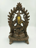 Large brass sculpture of Ganesh sitting under decorative arch