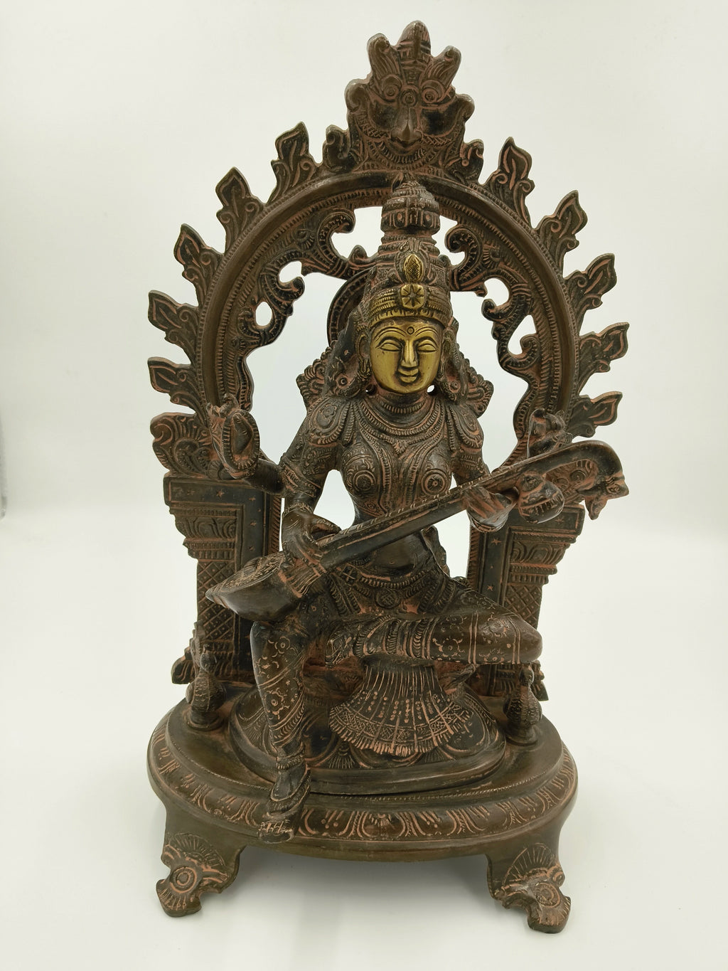 Brass sculpture of goddess Saraswathi seated with arch and veena
