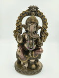 Large polyresin sculpture of Hindu deity Ganesh seated on ornate base with decorative arch