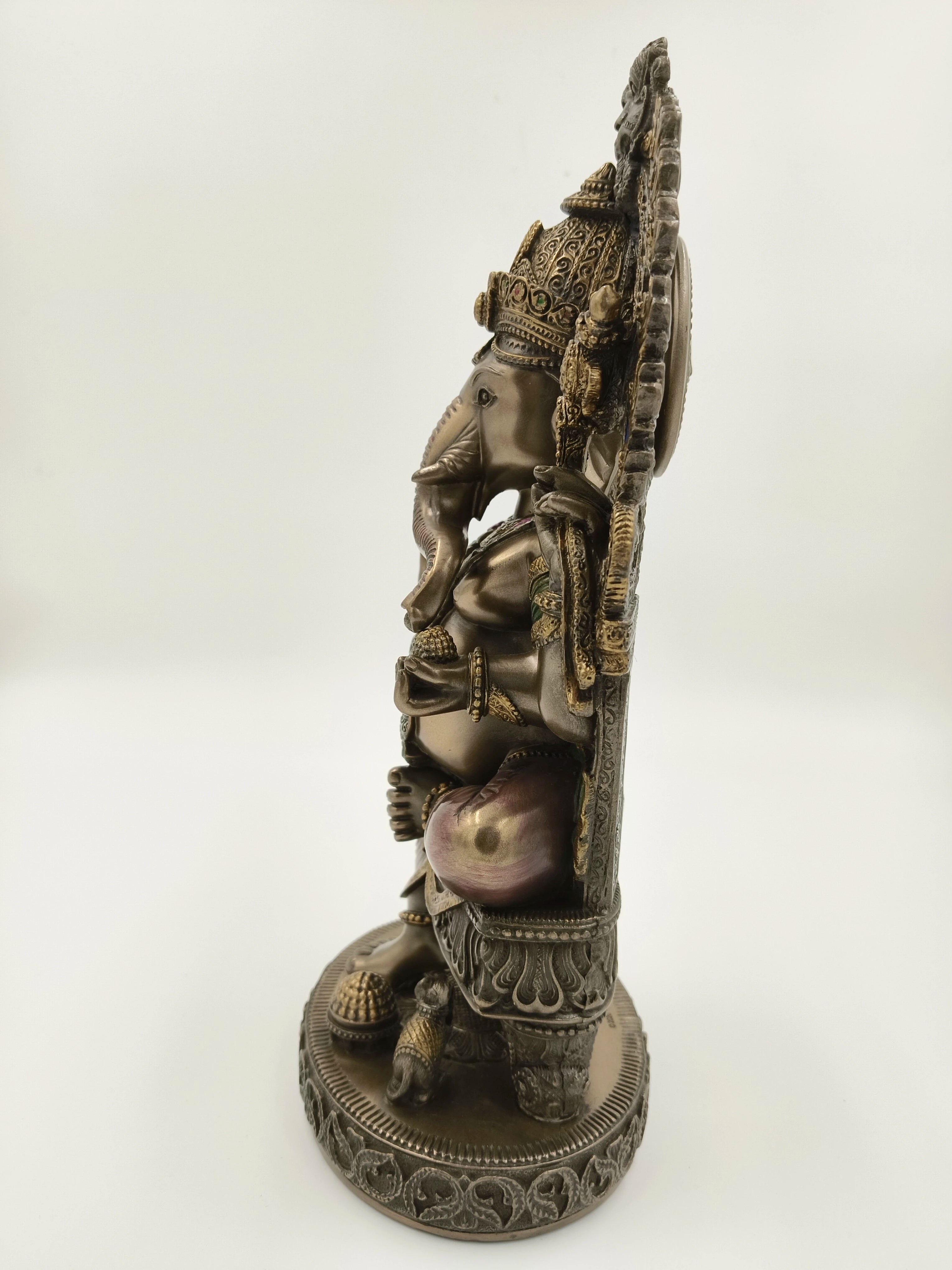 Side view of a large polyresin Ganesh sculpture seated on ornate throne