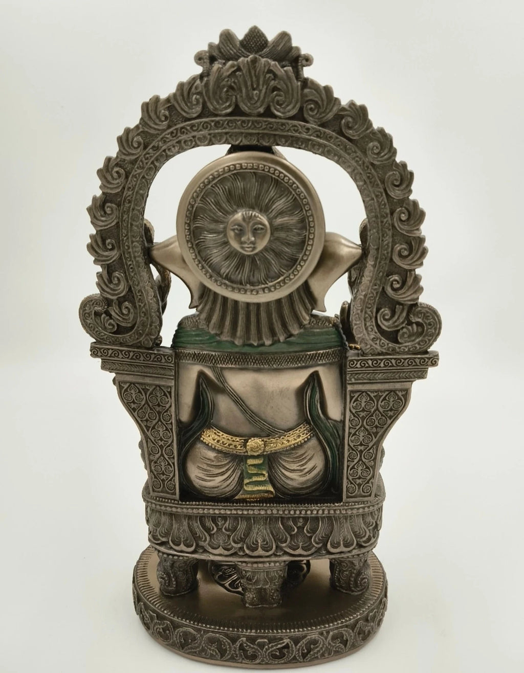 Back view of ornate metal Ganesh statue with detailed carvings and sun motif