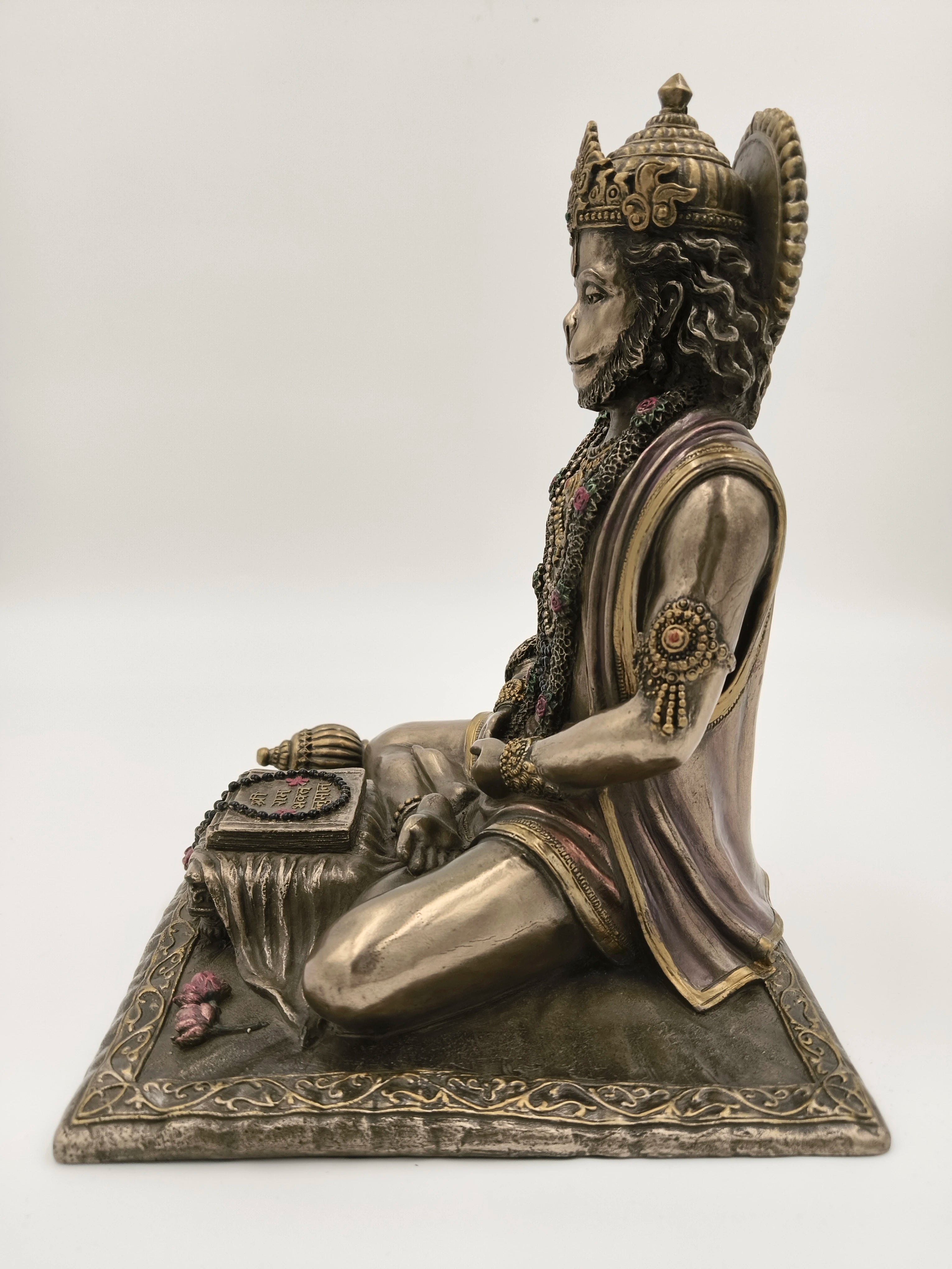 Side view of polyresin sculpture of Hanuman in dhyan mudra on decorated base