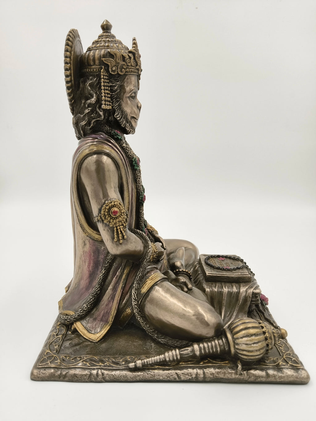 Side view of polyresin sculpture of Hanuman in dhyan mudra seated with mace and scripture