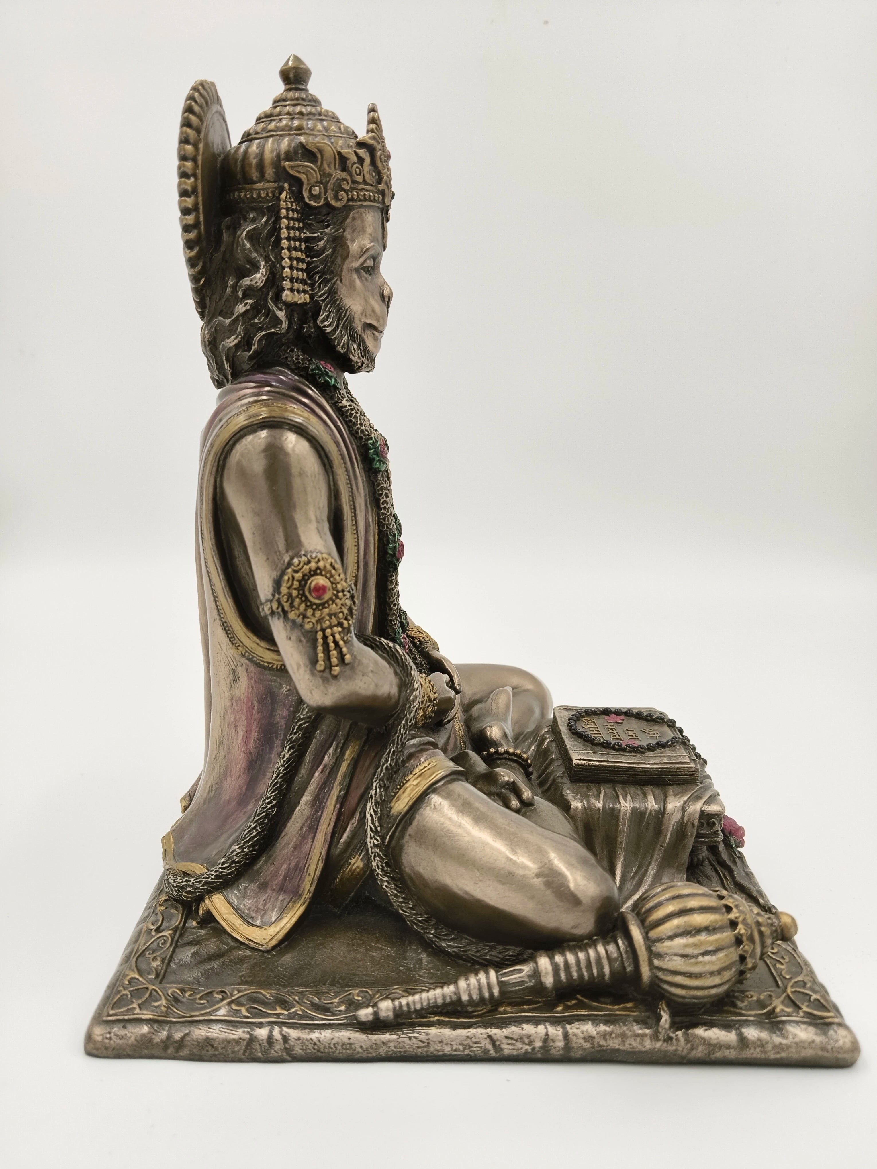 Side view of polyresin sculpture of Hanuman in dhyan mudra seated with mace and scripture