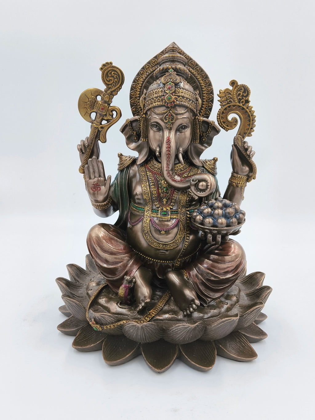 Large polyresin statue of Ganesh seated on a lotus holding various objects