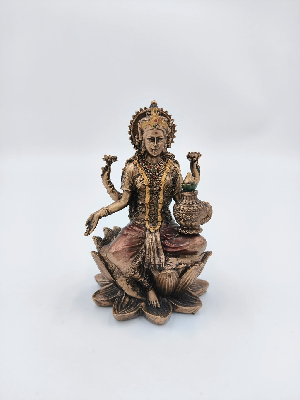 Small polyresin Lakshmi statue seated on lotus with Kalash in hand