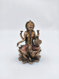 Small polyresin Lakshmi statue seated on lotus with Kalash in hand