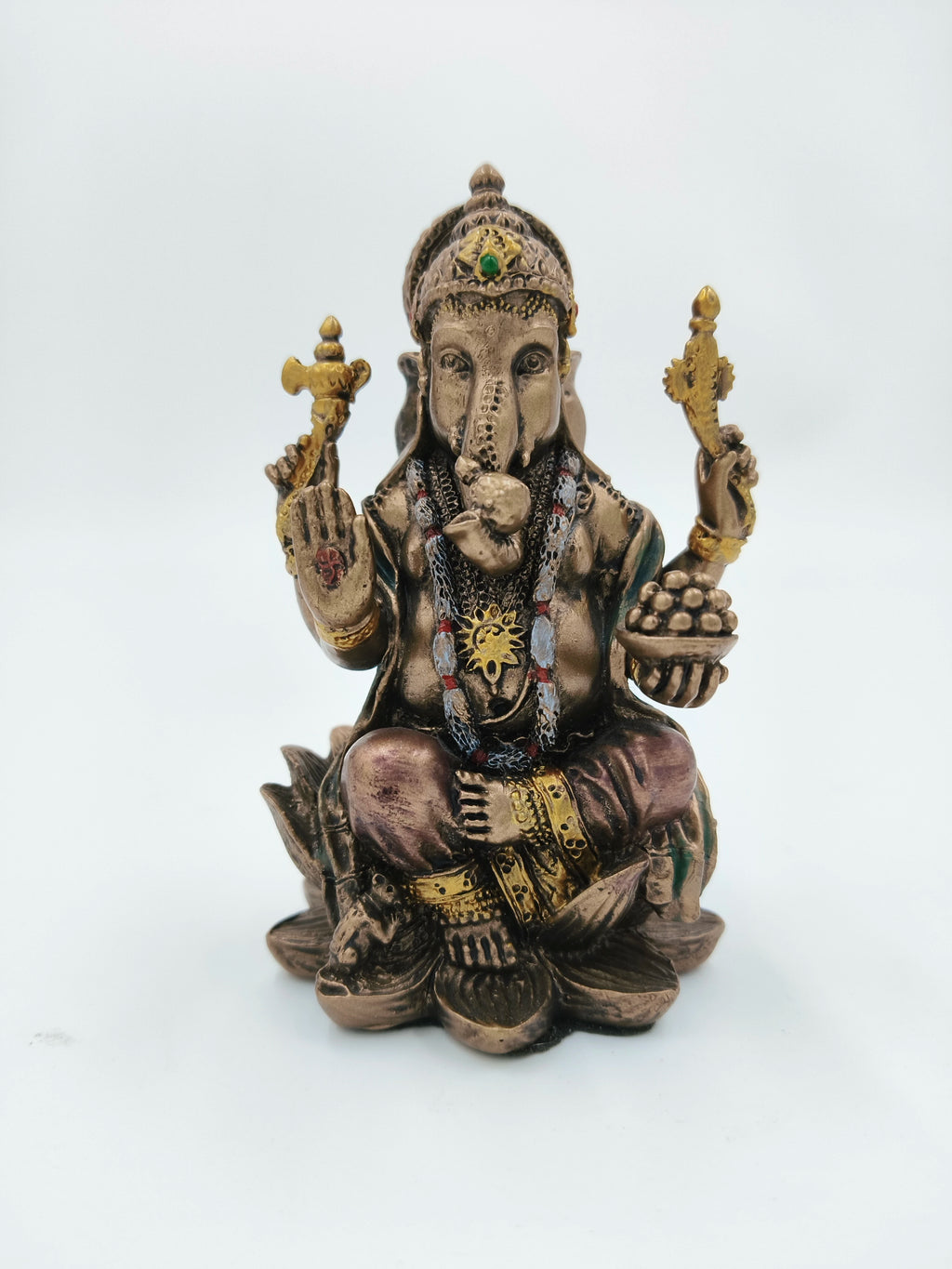 Small polyresin Ganesh statue sitting on lotus with detailed ornaments