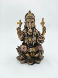 Small polyresin Ganesh statue sitting on lotus with detailed ornaments