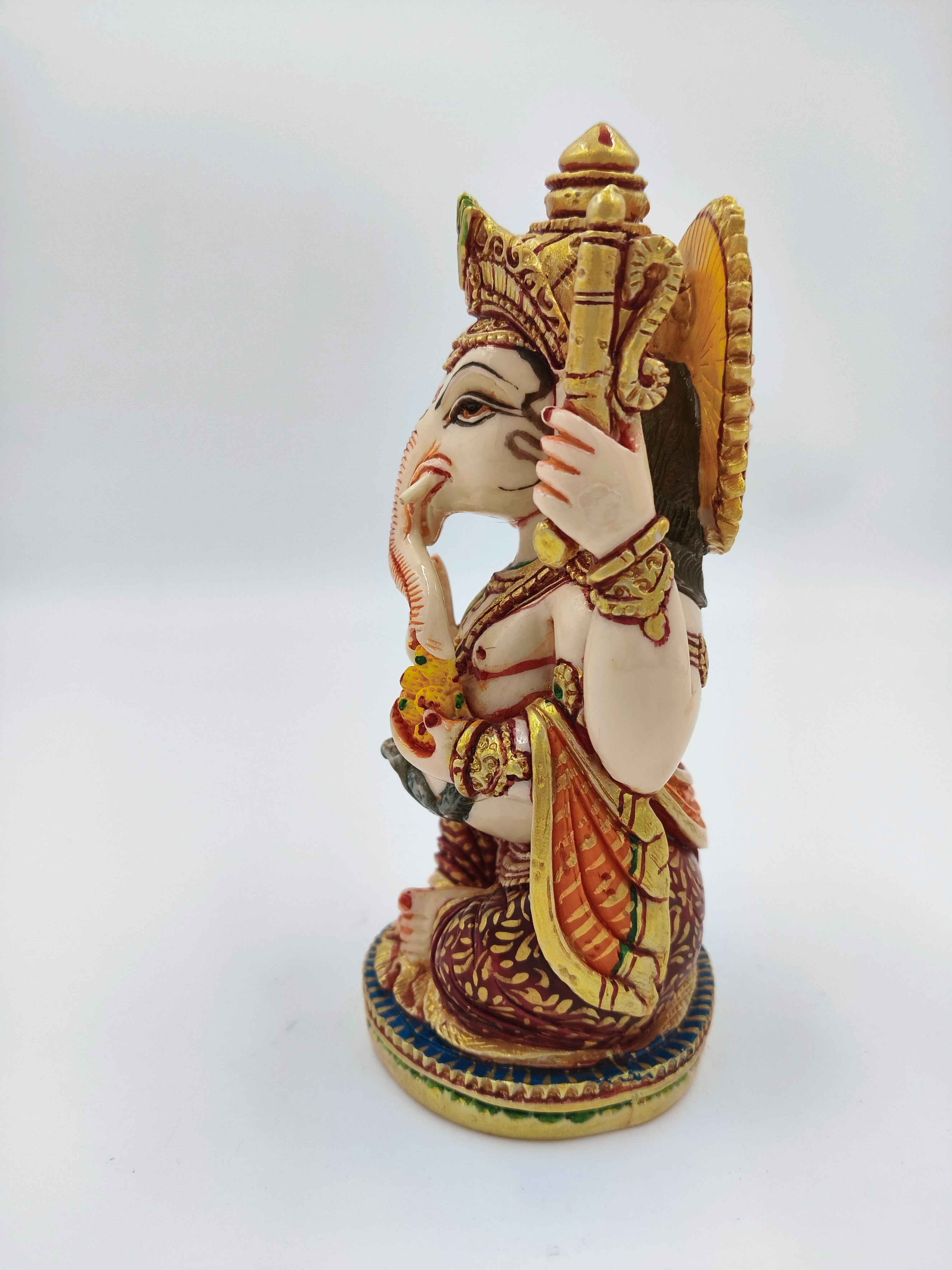Side view of polyresin Ganesh statue with detailed colorful decorations